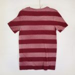 Back of Stripes Danga model on burgundy organic cotton unisex tshirt